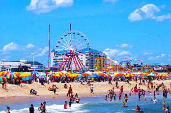 people on Ocean City, NJ beach with ferris wheel in background